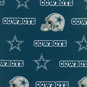 May include: A blue fabric with a repeating pattern of the Dallas Cowboys logo, including a white star, the words "COWBOYS", and a football helmet.