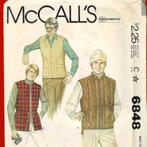 May include: Vintage McCall's sewing pattern featuring illustrations of men's vests. The pattern cover shows three different vest styles, including a quilted brown vest, a plaid vest, and a tan vest. The pattern number is 6848.