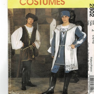 May include: A sewing pattern for a medieval costume. The pattern includes instructions for a long, white robe with a blue sash and a brown tunic with a belt. The pattern is for size Z (large-extra large).