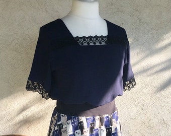 Top, flowing crepe tunic and light navy blue adorned with black lace