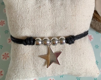 Women's bracelet with star charm and solid silver beads mounted on an adjustable black cord