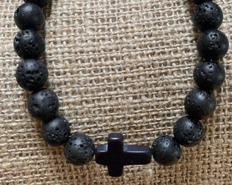 Men's elastic bracelet made of round black lava stone beads with horizontal cross