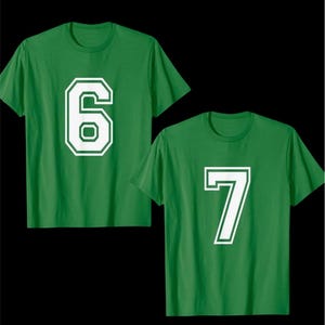 May include: Two green t-shirts, each displaying a large white number. One shirt features the number 6, and the other displays the number 7. The numbers have a white outline.