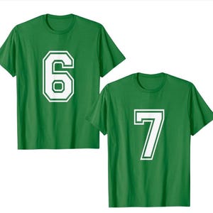 May include: Two green t-shirts, each with a large white number. One shirt displays the number 6, and the other displays the number 7. The numbers have a white border. The shirts are short-sleeved.
