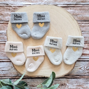 Multi-colored baby socks and pregnancy announcement - mini us theme