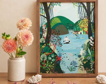 May include: A framed art print featuring a colorful landscape illustration of a lake, green hills, trees, and a boat, displayed next to a white ceramic vase containing three peach-colored dahlia flowers and two pieces of white coral.
