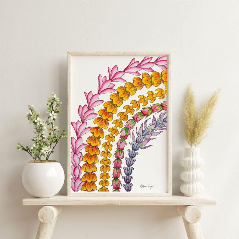 May include: A framed art print featuring a colorful floral design in a rainbow arc. The artwork showcases a variety of flowers in shades of pink, yellow, orange, and purple. The print is displayed on a light-colored wooden shelf.