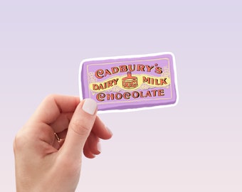 May include: A purple sticker with a white border featuring the Cadbury's Dairy Milk chocolate logo. The logo is in a vintage style with a red and yellow color scheme. The text reads "Cadbury's Dairy Milk Chocolate".