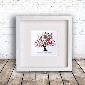 May include: A white framed picture with a black silhouette of a tree with purple, pink, and red buttons on the branches. The name "Alice" is written in blue above the tree. The text "Always remember you are braver than you think" is written below the tree.