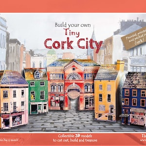 May include: Build your own Tiny Cork City, a 3D paper model kit featuring colourful buildings with intricate details. The kit includes five buildings, including a red building with a large archway. The buildings are painted, printed, and packed in Cork, Ireland.