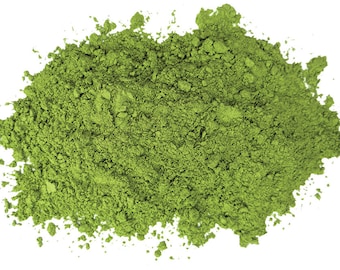 May include: A pile of bright green matcha powder, a finely ground green tea powder, isolated on a white background.