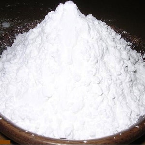 May include: A white powder, possibly cornstarch or flour, piled high in a wooden bowl.