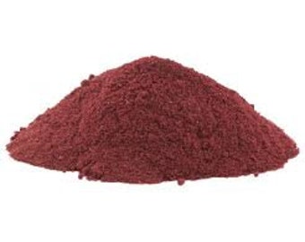 May include: A pile of loose, dark red powder.