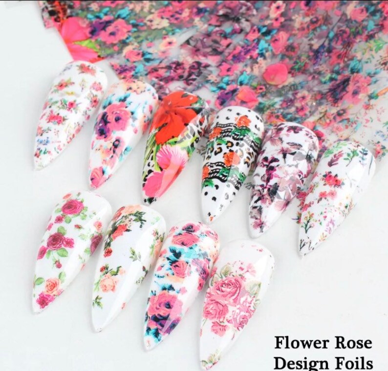 Puede incluir: Surtido de l&aacute;minas de u&ntilde;as florales con varios dise&ntilde;os con flores rosas, rojas y blancas. Las l&aacute;minas est&aacute;n etiquetadas como "Flower Rose Design Foils".