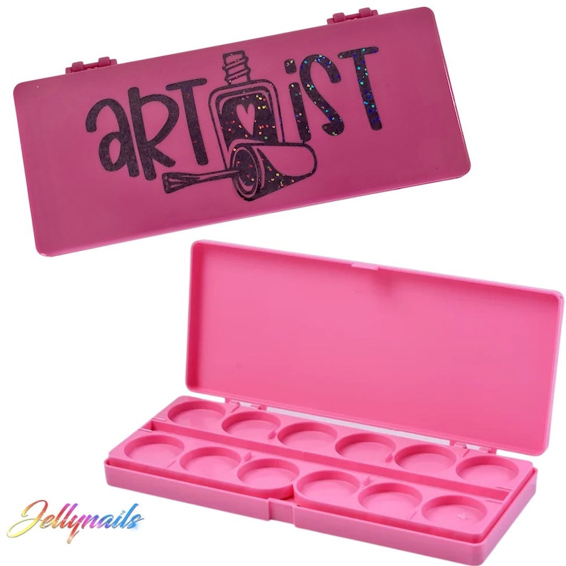 May include: A bright pink nail art palette with the word "artist" and a nail polish bottle design on the lid. The palette is open, revealing 12 circular wells for holding nail art supplies.