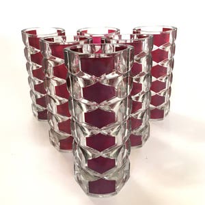 May include: Set of six clear glass tumblers with a geometric design and a burgundy coloured band around the middle of each glass.