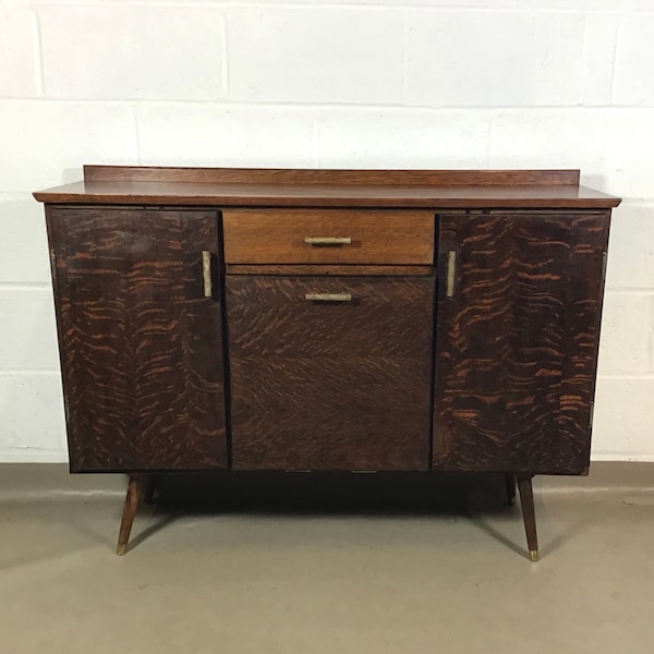 A 1950's oak sideboard with original celluloid handles