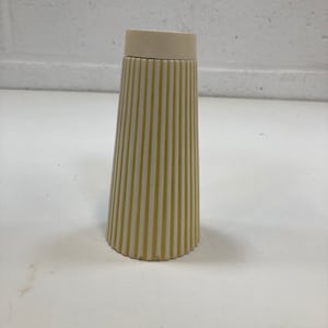 May include: A white and yellow striped ceramic salt and pepper shaker with a white lid.