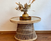 Round 70s table with a rattan frame.
