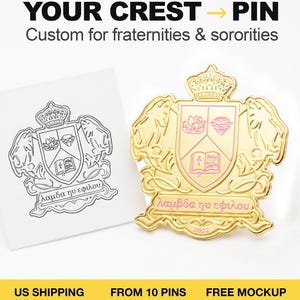 May include: A gold-toned metal pin featuring a crest design with a crown, two lions, and a shield containing a flower, a diamond, and an open book. The pin includes pink enamel accents and Greek text. Beside it is a black and white line drawing of the same crest.