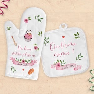 Peut inclure: Ensemble de manique et de gant de cuisine blancs avec des motifs floraux et du texte. Le gant de cuisine présente un cupcake, une cuillère en bois et du texte. Le dessous de plat a du texte et un cœur.