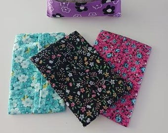 May include: Four rectangular fabric tissue holders featuring various floral patterns. One holder is purple with white and black flowers, while the others display teal, black, and pink backgrounds with intricate multi-colored floral prints.