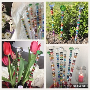 May include: Colorful beaded garden stakes with crystal tops. The stakes are made with various colored beads and have a crystal top. The stakes are shown in a variety of settings, including a flower garden and a table top.