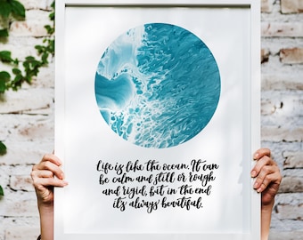 May include: A framed print with a blue and white abstract circle design and the text "Life is like the ocean. It can be calm and still or rough and rigid, but in the end it's always beautiful."
