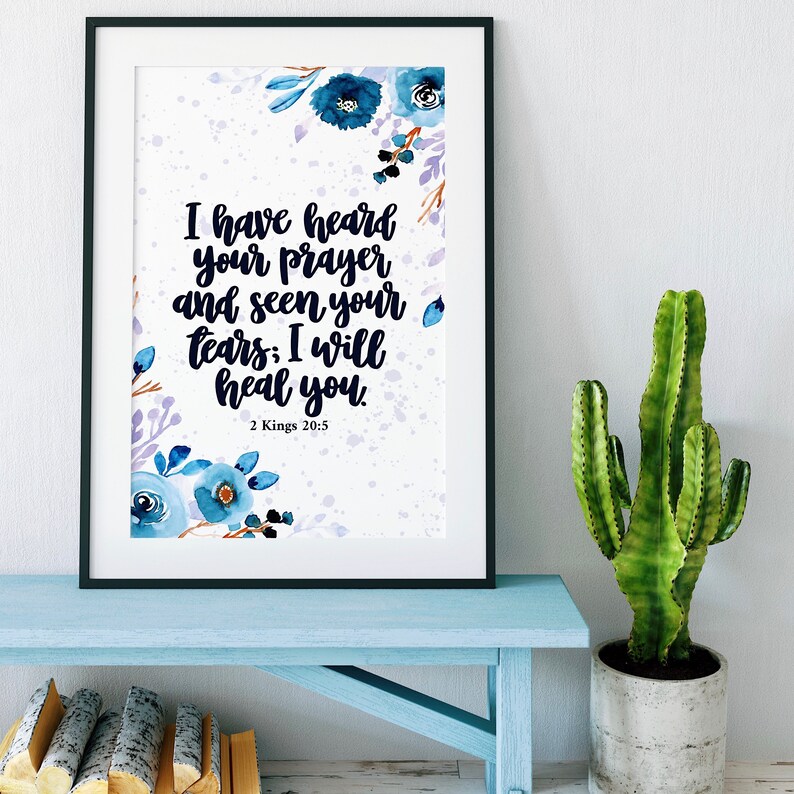 May include: A framed print with a watercolor floral design in shades of blue and purple. The print features a bible verse: "I have heard your prayer and seen your tears; I will heal you." 2 Kings 20:5