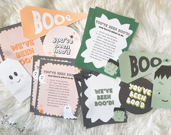 May include: A set of printable Halloween party decorations featuring a ghost and Frankenstein theme. The decorations include signs that say "You've Been Boo'd!" and "We've Been Boo'd!" along with instructions on how to play the "Boo'd" game.