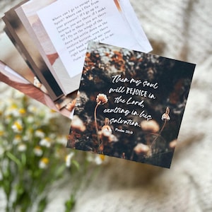 May include: A dark brown card with a white floral background and a quote from Psalm 35:9. The quote reads "Then my soul will rejoice in the Lord, exulting in his salvation."