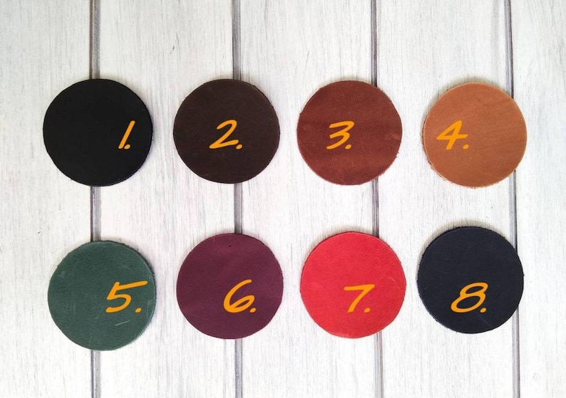 May include: Eight round leather swatches in different colors, numbered 1 through 8. The swatches are arranged in two rows of four.