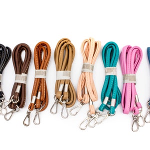 May include: Assortment of ten leather straps with silver clasps in various colors, including black, brown, tan, peach, teal, pink, and blue.