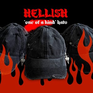 May include: Three black distressed baseball caps with safety pin and charm accents. The caps have a worn look with tears and rips. The word "HELLISH" is written in red, stylized font above the hats, with the text "*one of a kind* hats" below.