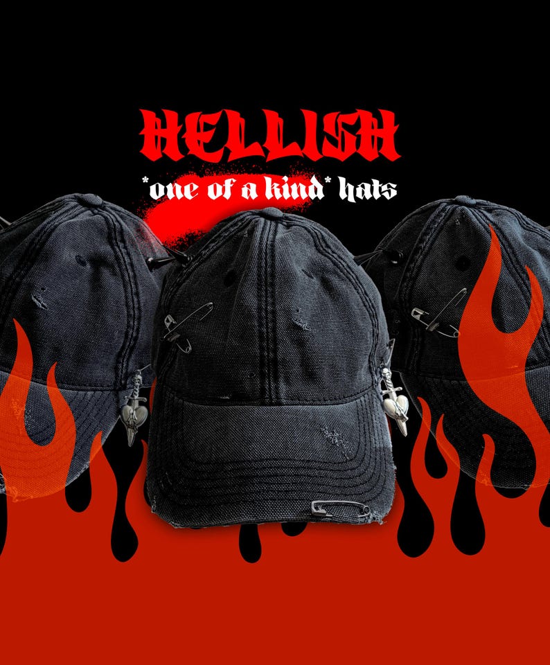 May include: Three black distressed baseball caps with safety pin and charm accents. The caps have a worn look with tears and rips. The word "HELLISH" is written in red, stylized font above the hats, with the text "*one of a kind* hats" below.