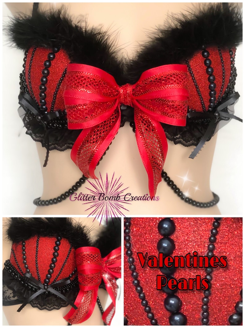May include: A red and black lingerie top with a large red bow and black feather trim. The top is embellished with black beads and lace. The text "Valentines Pearls" is visible in the image.