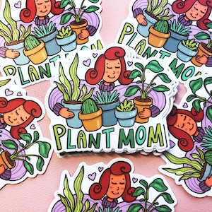 May include: A set of colorful stickers featuring a cartoon woman with red hair holding various potted plants. The stickers say "Plant Mom" in a whimsical font.
