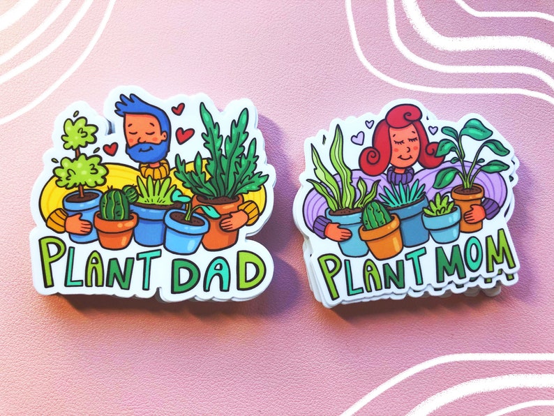 May include: Two stickers with cartoon illustrations of people holding potted plants. The sticker on the left says "Plant Dad" and the sticker on the right says "Plant Mom".