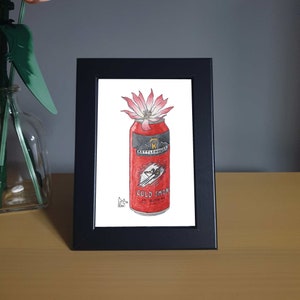 May include: A framed illustration of a red can of Kettle House Brewing's Cold Smoke Scottish Ale with a pink flower growing out of the top.