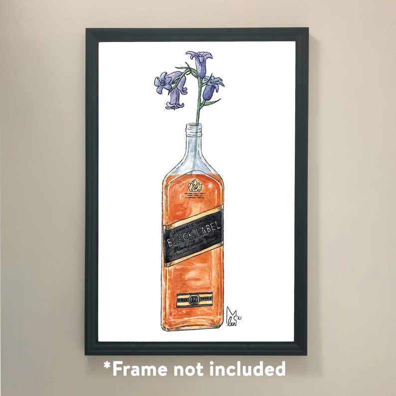 May include: Watercolor art print of a Johnnie Walker Black Label bottle with blue flowers in it. The bottle is filled with amber liquid and has a black label. The artwork is framed in a black frame.