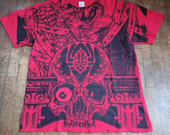May include: Red t-shirt with a black and white skull graphic print. The skull has a third eye and is surrounded by other graphic elements. The shirt has the text "IMF" printed on the bottom.