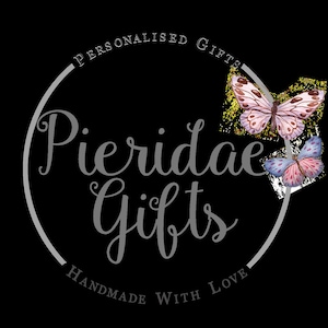 May include: A grey circle with the text "Personalised Gifts" and "Handmade with Love" around the edge. The text "Pieridae Gifts" is in the centre of the circle. Two butterflies are on the right side of the circle, one is pink and white and the other is pink, white, and blue.