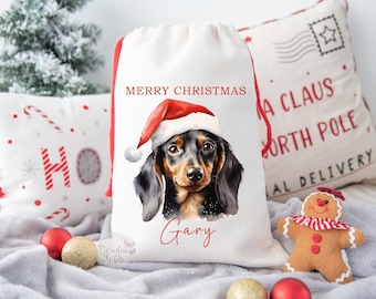 May include: A white Christmas stocking with a red trim and the words "Merry Christmas" printed on it. A dachshund wearing a Santa hat is illustrated on the stocking. The name "Gary" is printed below the dog.