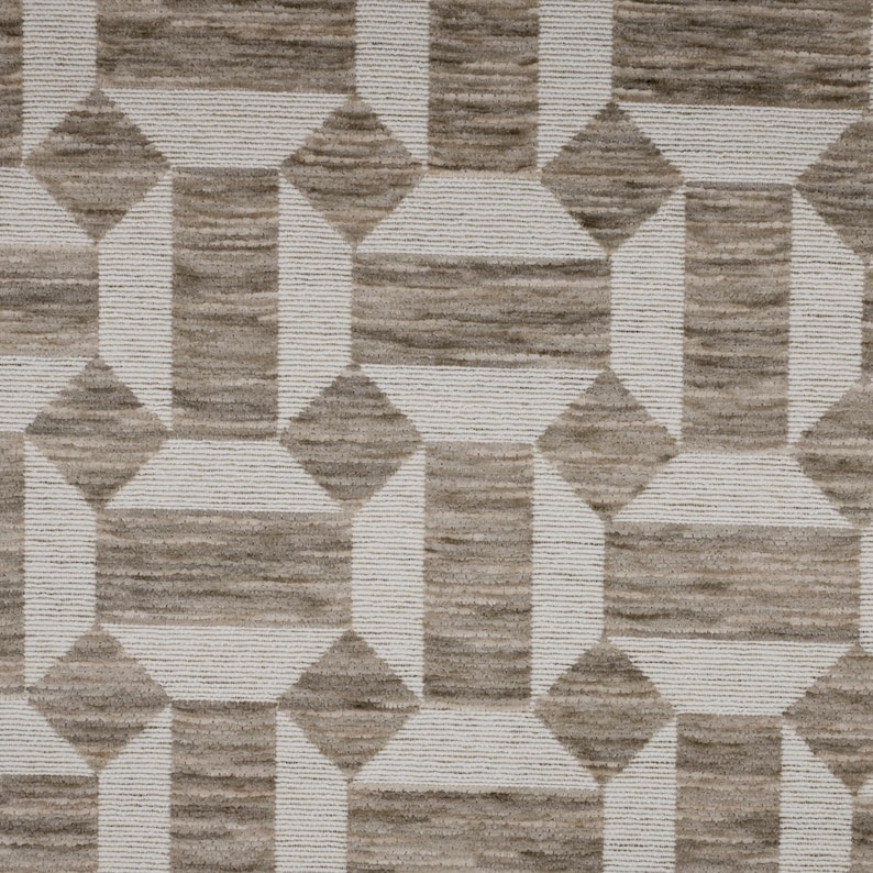 May include: A textile fabric featuring a repeating geometric pattern of taupe and white shapes. The design consists of alternating taupe rectangles and white linear borders that form interconnected octagonal and diamond-like motifs throughout.