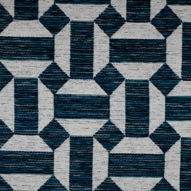 May include: A textile fabric featuring a repeating geometric pattern of white octagons and rectangles interconnected with dark teal and navy blue horizontal striped sections. The surface has a visible woven texture with a consistent color scheme.