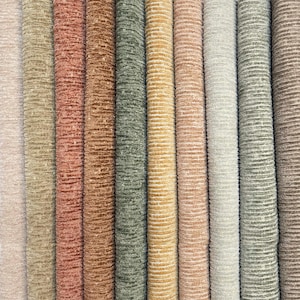 May include: A collection of eleven vertical fabric swatches featuring a textured, ribbed corduroy pattern. The colors include shades of light pink, tan, terracotta, brown, olive green, mustard yellow, dusty rose, cream, sage green, and dark brown.