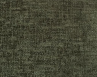 May include: A dark olive green fabric with a textured, woven appearance. The material features a subtle, mottled pattern created by variations in the weave, resulting in a dense, multi-tonal surface with a soft, matte finish throughout the textile.
