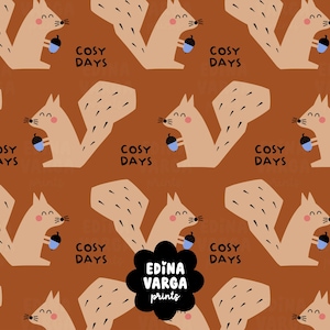 May include: A repeating pattern on a brown background featuring light brown squirrels with pink cheeks, each holding a blue acorn. The text COSY DAYS is printed in black next to each squirrel. A black scalloped badge displays EDINA VARGA prints.