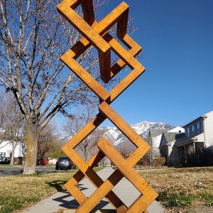Stacked Trefoils: Abstract geometric metal sculpture. Modern outdoor decor, yard art.