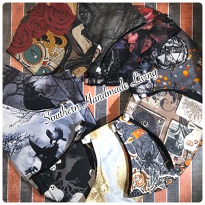 May include: A collection of 10 Halloween-themed face masks featuring various spooky designs, including a skull, a witch, a crow, a spider web, and a pumpkin. The masks are all made of fabric and have black elastic ear loops. The masks are arranged in a circle on a striped background. The text "Southern Handmade Living" is visible in the center of the image.